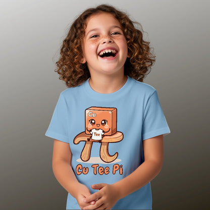 girl wearing blue Cu Tee Pi kids science t-shirt with cute copper cube sitting on pi symbol table