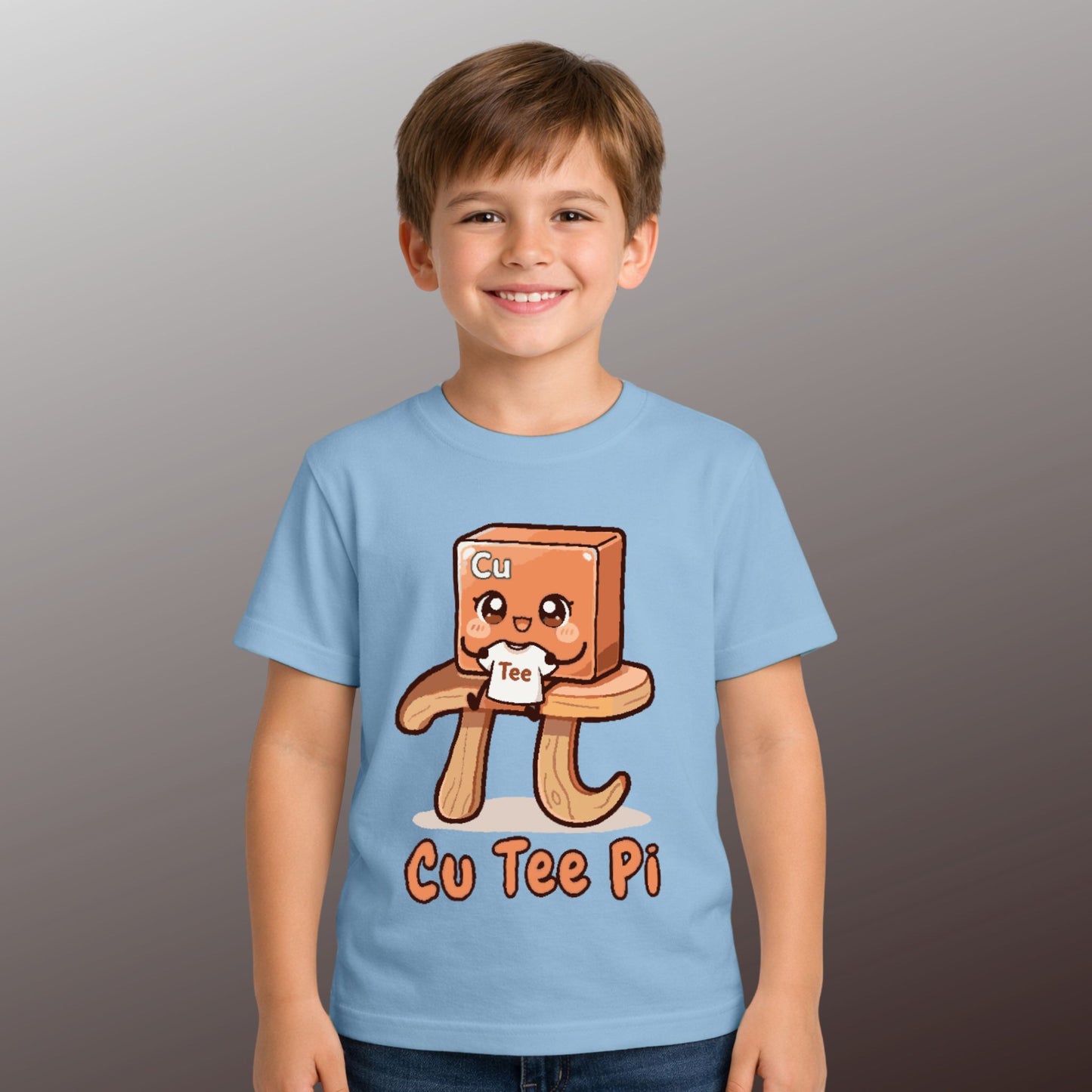 boy wearing cute Cu Tee Pi kids STEM blue t-shirt with copper cube cartoon sitting on a pi symbol table