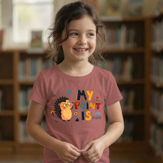 Young girl smiling in a mauve "My Point Is" hedgehog graphic t-shirt in a library setting