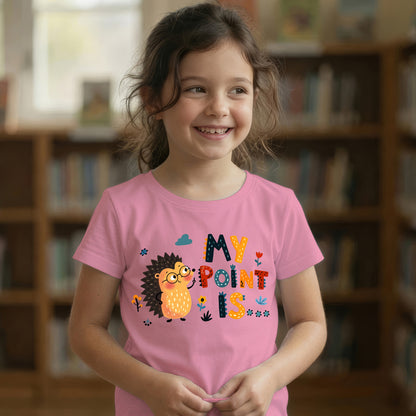 Young girl smiling in a pink "My Point Is" hedgehog graphic t-shirt in a library setting