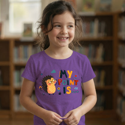 Young girl smiling in a purple "My Point Is" hedgehog graphic t-shirt in a library setting