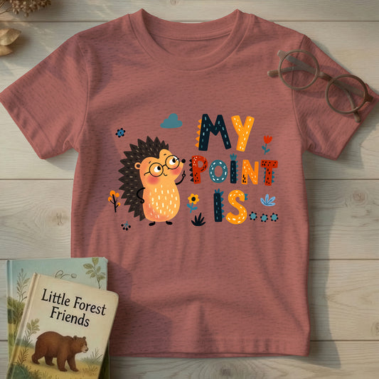 Mauve heather kids t-shirt with cartoon hedgehog in glasses and "My Point Is" quill-textured typography, flat lay on wood background